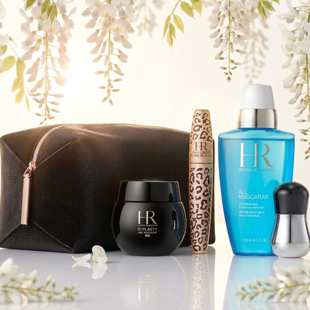 Productos Helena Rubinstein bajo glicinias blancas.​
