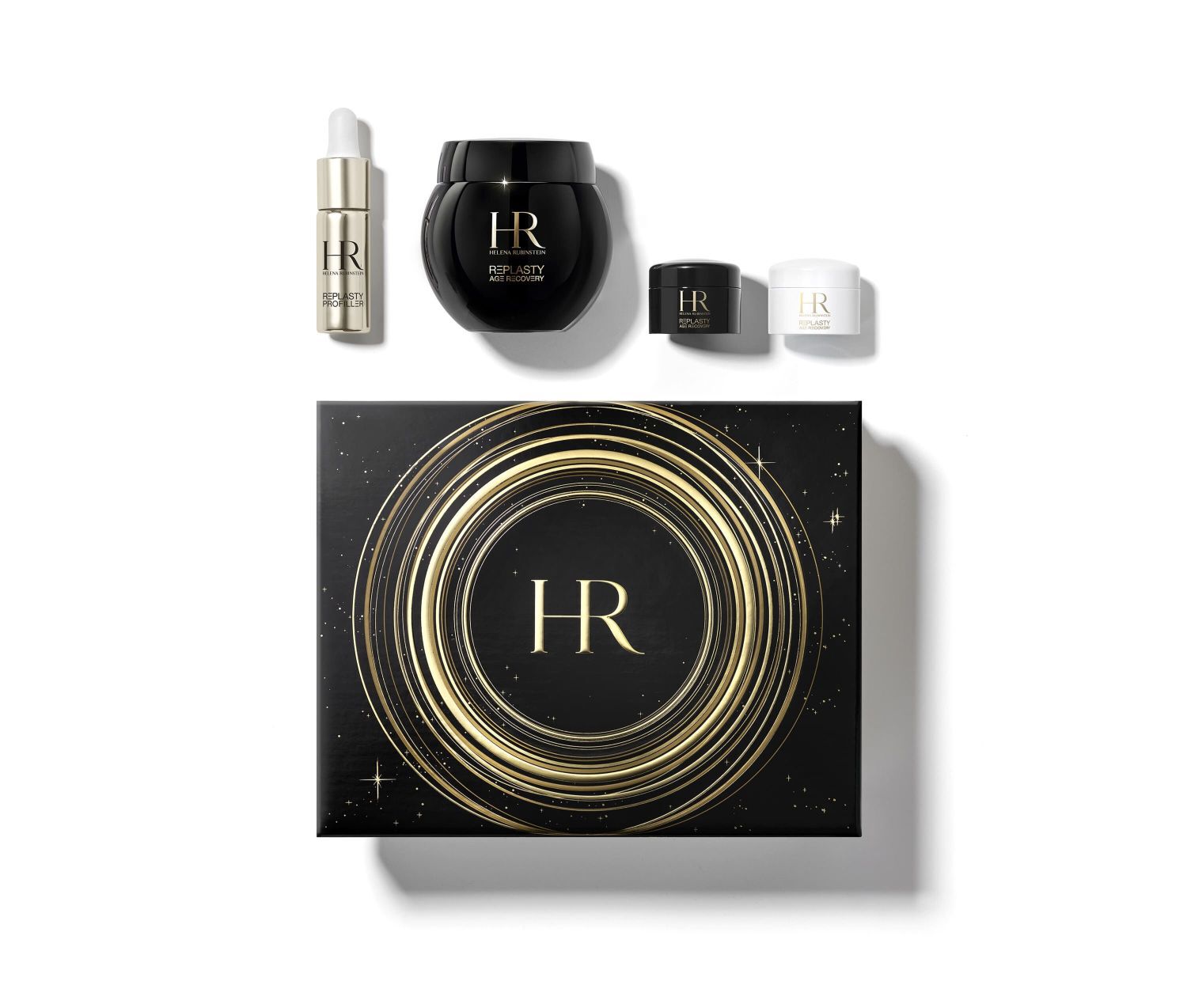 Caja de regalo negra decorada con espirales doradas y patrones de estrellas, abierta para mostrar cuatro productos Helena Rubinstein "Re-Plasty" en su interior, sobre fondo blanco.